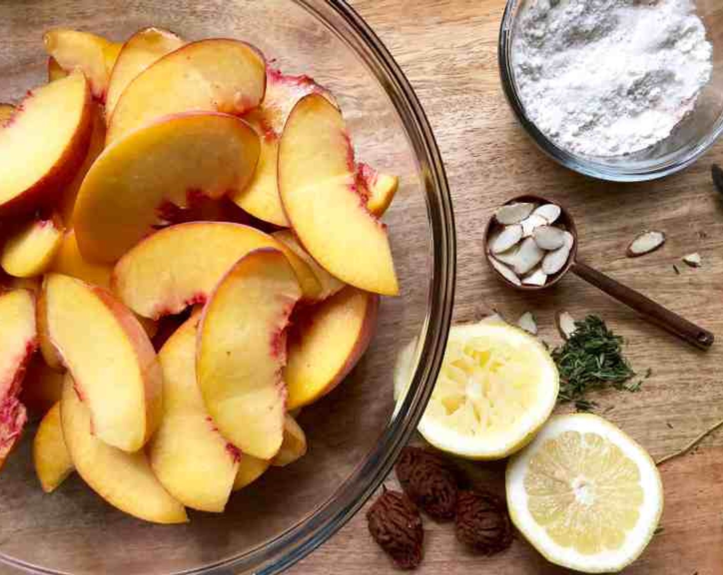 step 5 For the filling, add the Peaches (3 cups) and 1 Tbsp of Lemon (1/2) to a large bowl. Toss until coated.