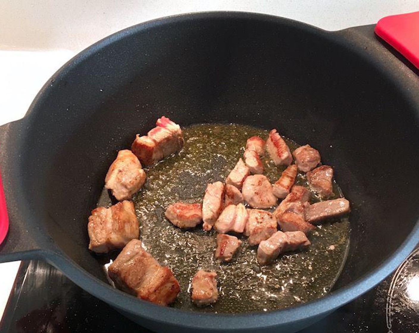 step 5 Heat Extra-Virgin Olive Oil (as needed) in a large Dutch oven over medium-high heat and brown pork cubes in batches. Remove and drain on paper towels and repeat until all meat is browned.