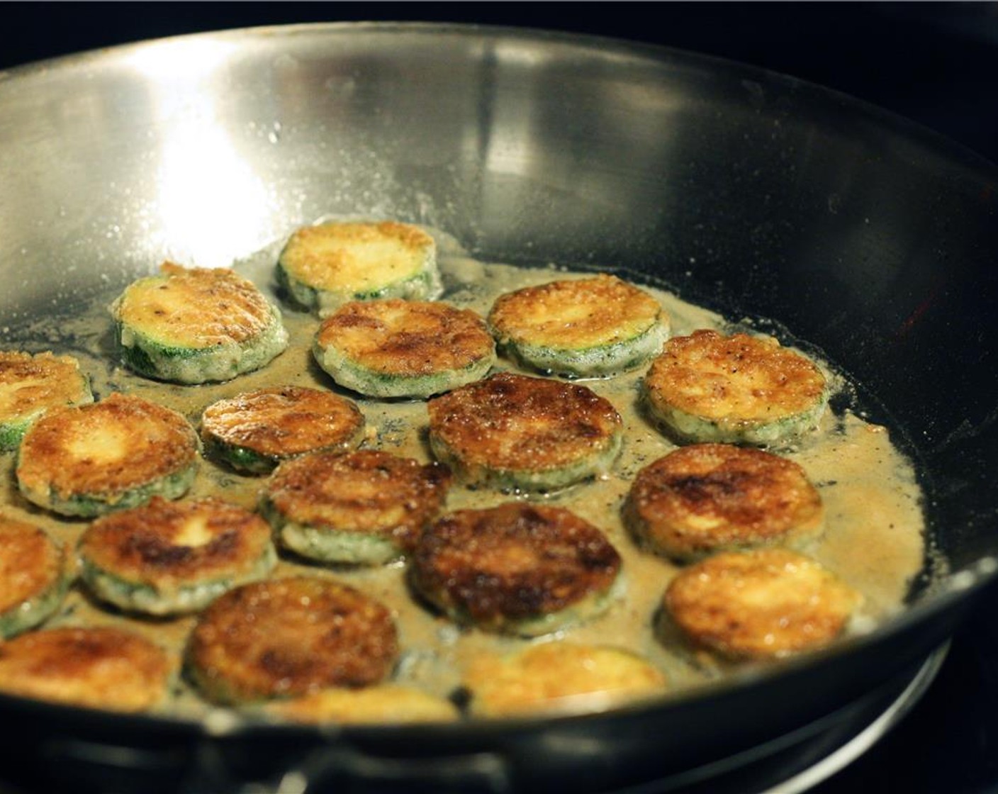 step 6 Gently flip each medallion with a fork and cook until both sides are golden brown. Remove from pan to a plate lined with napkins or paper towels. Continue until all zucchini is cooked, replenishing the oil in the frying pan as needed.