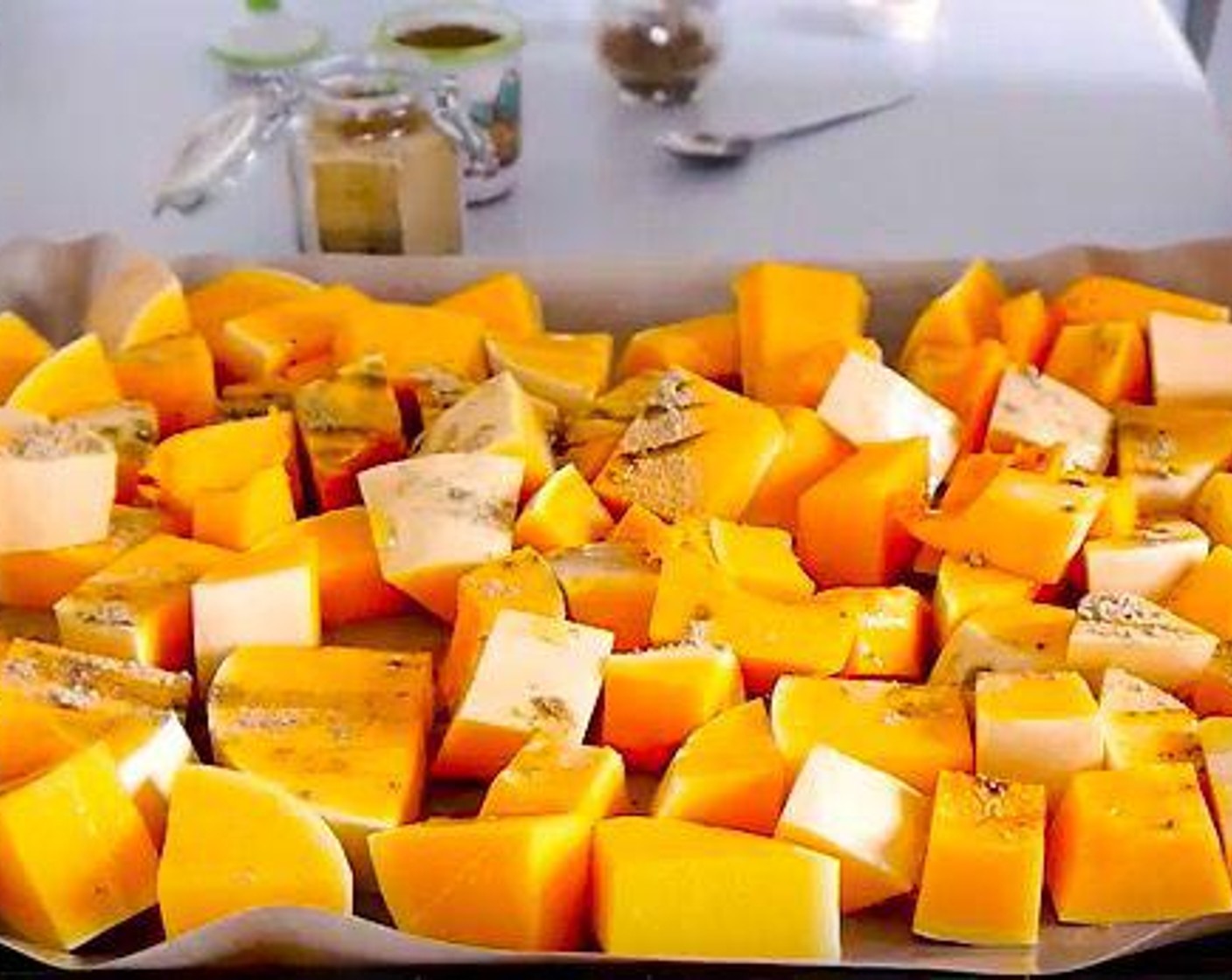 step 3 Put the cubed squash in a baking tray lined with parchment and season with Ground Ginger (2 tsp), Ground Cumin (1 tsp), Ground Black Pepper (to taste), Smoked Salt (1 tsp), Salt (1 tsp), and Olive Oil (as needed). Use your hands to mix well. Roast for 40 to 45 minutes in the preheated oven or until soft.