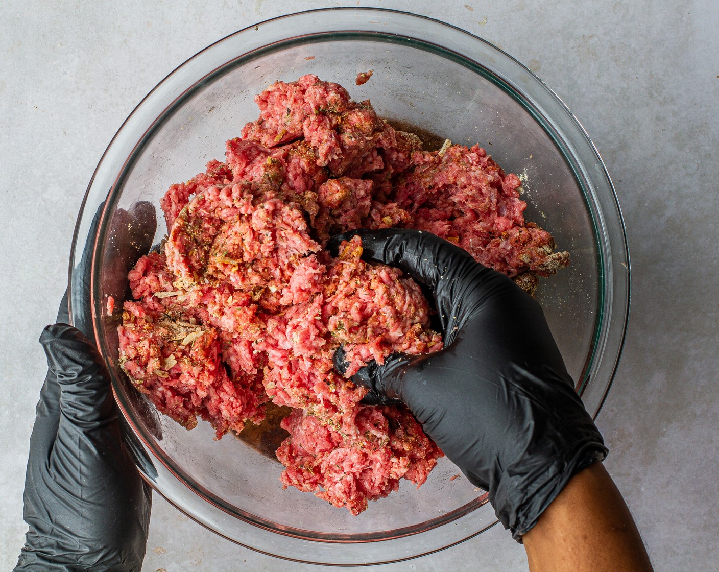 step 3 In a large bowl, mix the 80/20 Lean Ground Beef (2 lb) with Onion Soup Dry Packet (2), Onion Powder (1/2 Tbsp), McCormick® Garlic Powder (1/2 Tbsp), Dried Thyme (1/2 Tbsp), Worcestershire Sauce (2 Tbsp), ½ teaspoon Kosher Salt (1/2 tsp), and ½ teaspoon Ground Black Pepper (1/2 tsp). Mix until well combined.