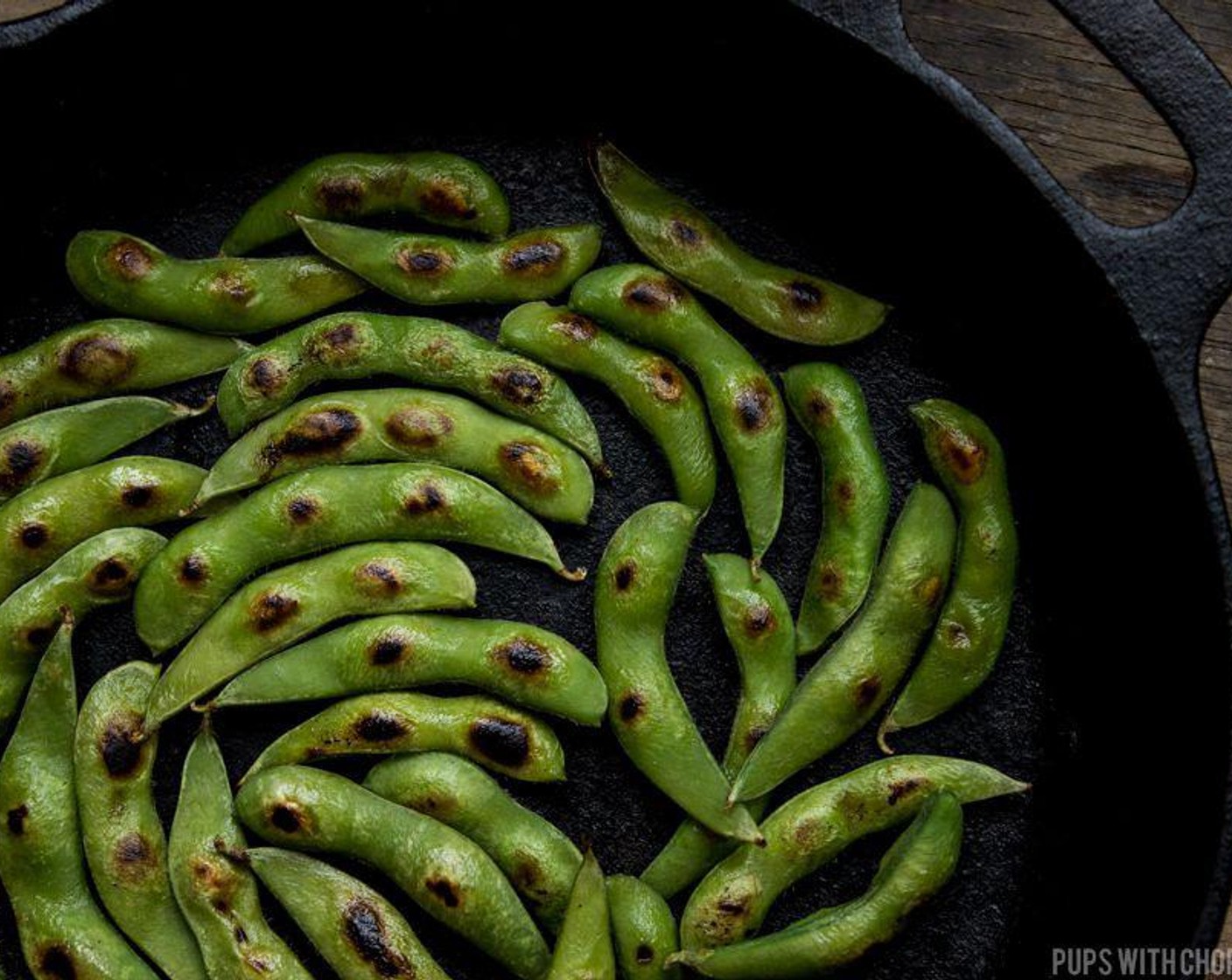 step 3 Once the pan is very hot, add the edamame in, in a single layer. We want to make sure the pods are touching the bottom of the pan. Char it for 2-3 minutes per side.