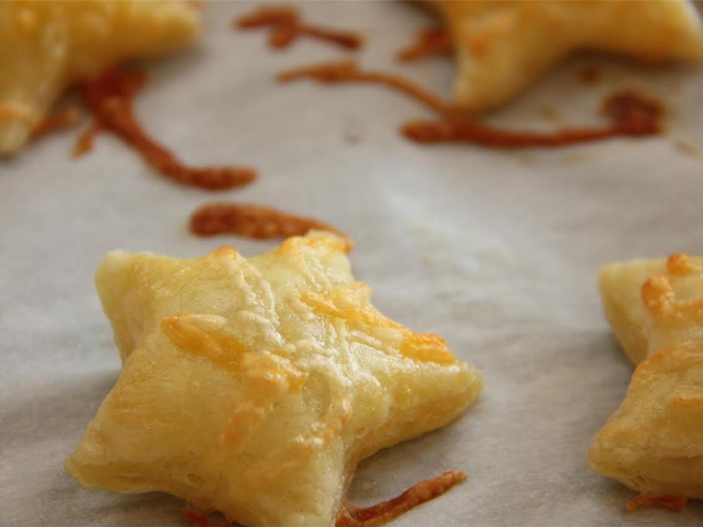 Step 6 of Easy Peasy Cheesy Puffs Recipe: Bake for 10 minutes or until cheese has melted and pastry puffed.