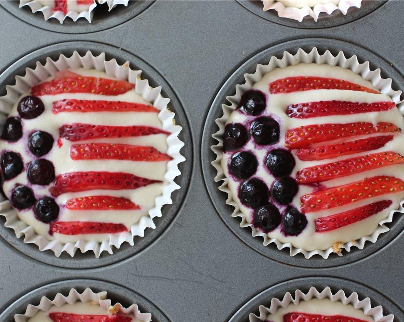 step 9 Using a toothpick through the fruit, carefully push the strawberries and Frozen Blueberries (1/2 cup) into the cheesecakes into your favorite stars and stripes pattern.