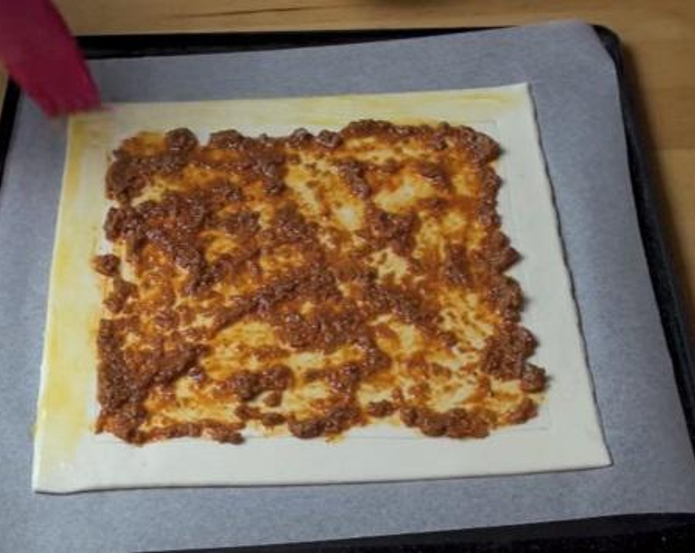 step 3 Add the Basil Pesto (2 Tbsp) with in the border you made on the pastry. Brush the border bits along the edge with 1 Egg (1).