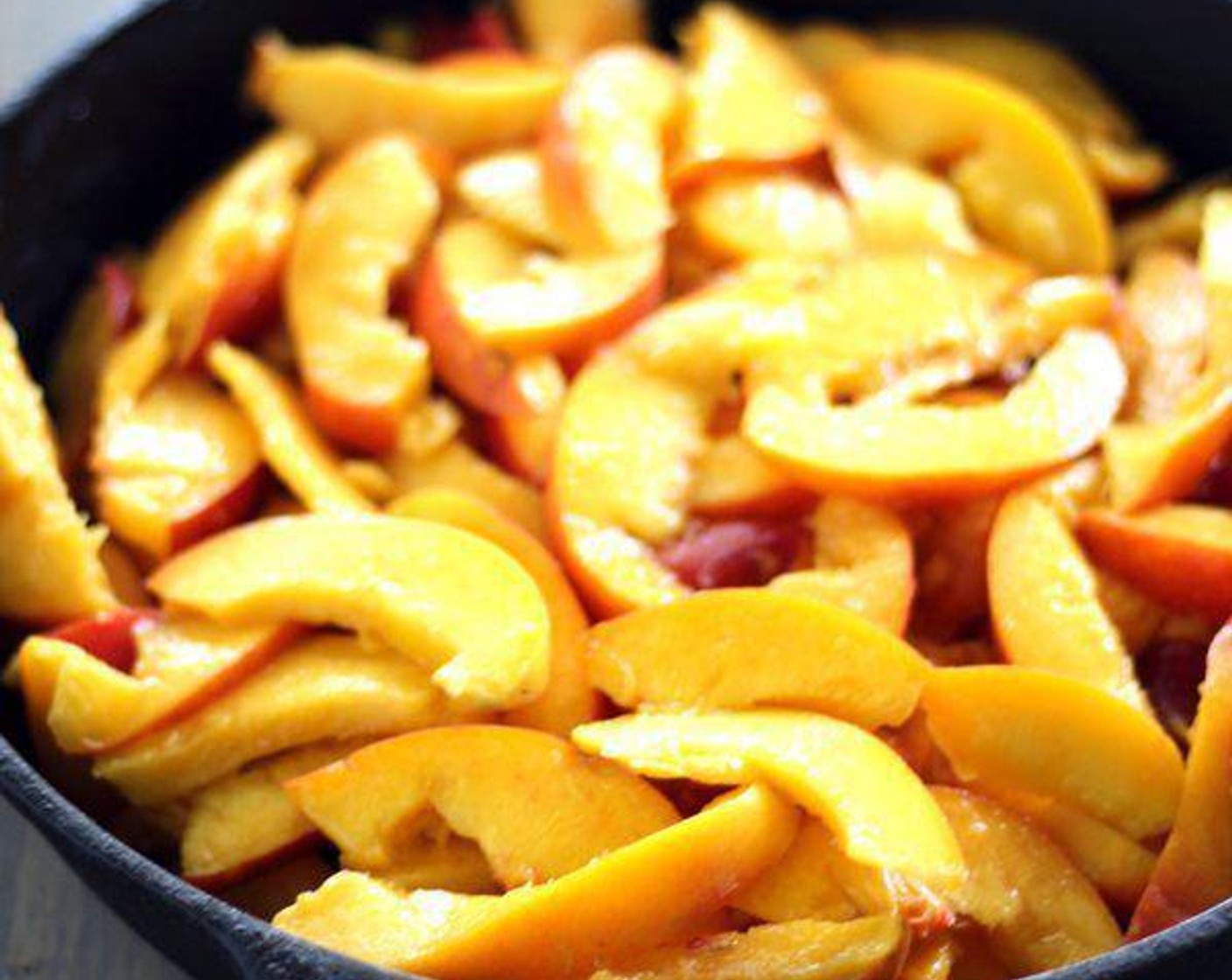 step 2 In a 10 inch cast iron skillet, heat Butter (2 Tbsp) over medium heat. Add the Peaches (8), Granulated Sugar (2/3 cup), juice from Lemon (1), Vanilla Extract (1/2 tsp), Ground Ginger (1 pinch), and Salt (1 pinch). Stir and cook the peaches until bubbly, about 5 minutes.