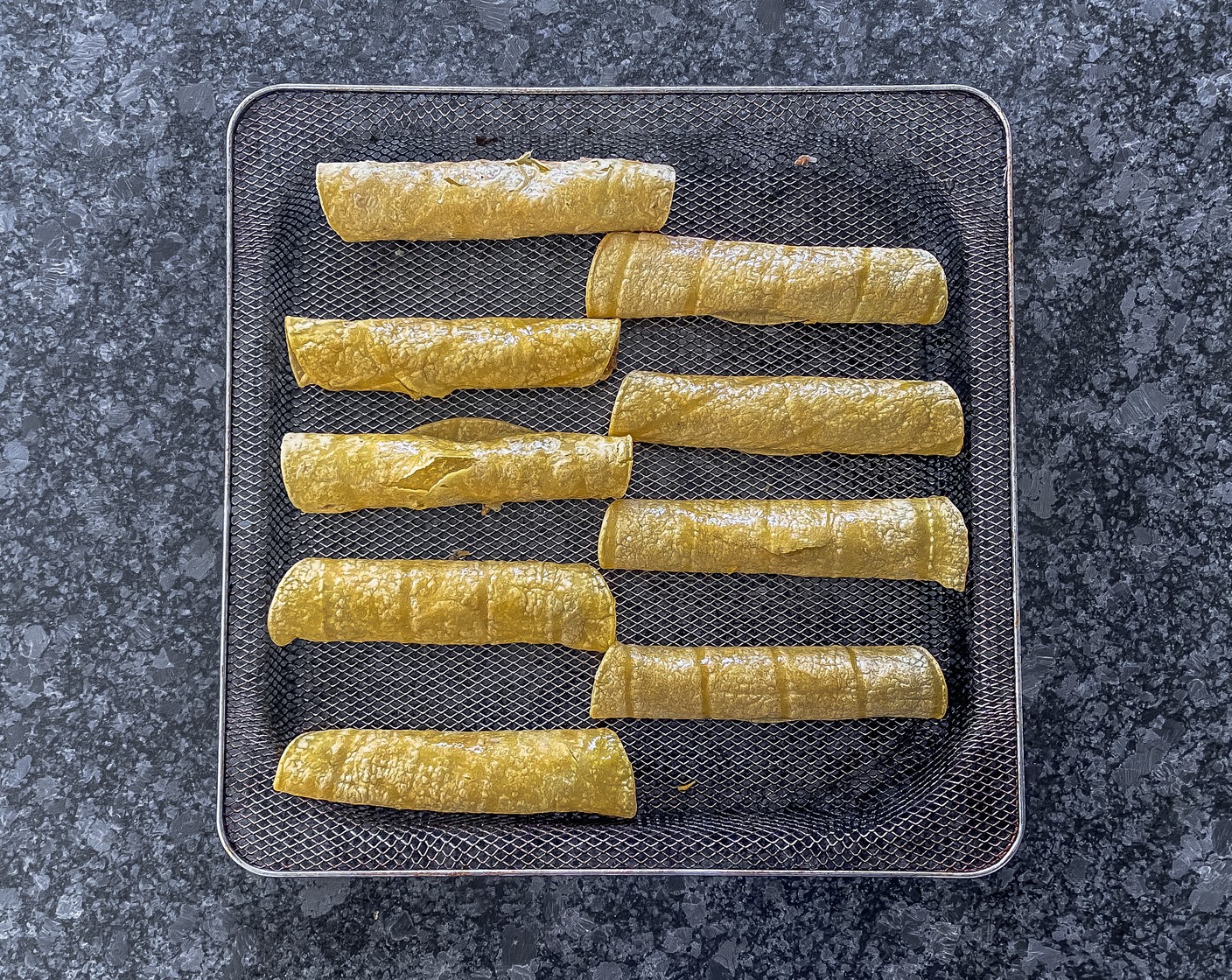 step 5 Preheat the air fryer to 400 degrees F (200 degrees C). Evenly space out rolled tacos in the air fryer seam down.