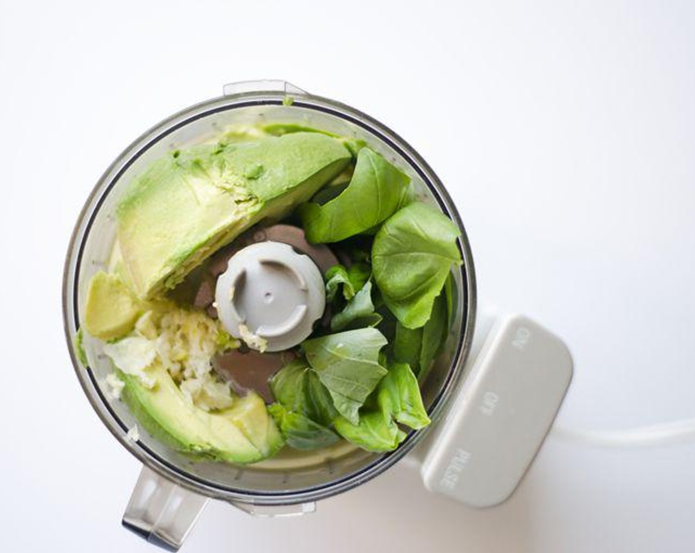 step 1 In a food processor, blend Avocado (1), Garlic (1 clove), Fresh Basil (1/2 cup), and 1 Tbsp of juice from Lemon (1) until smooth, then mix in Extra-Virgin Olive Oil (2 Tbsp).