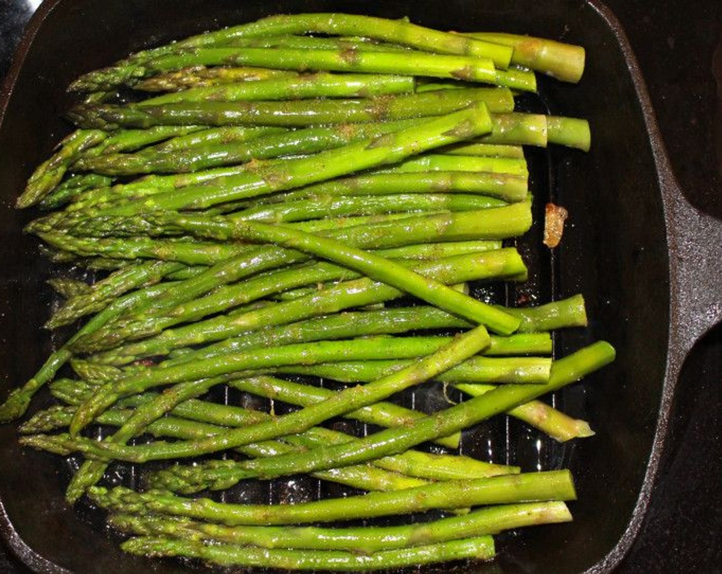 step 8 Repeat the seasoning with the asparagus. Coat in Peanut Oil (1/2 Tbsp), Kosher Salt (to taste), Cayenne Pepper (to taste), and Granulated Garlic (to taste), Grill asparagus until heated through and there are grill marks.