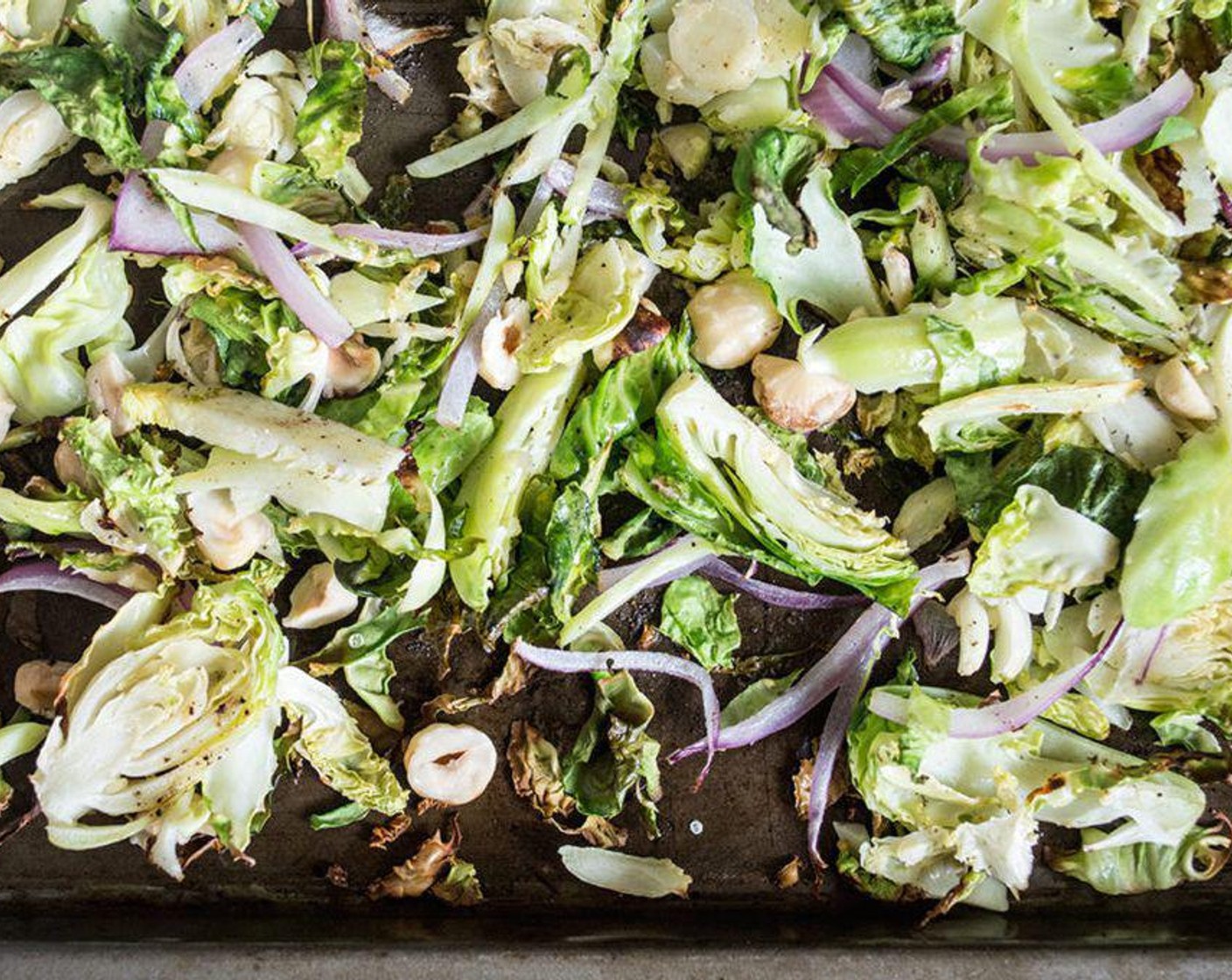 step 2 Spread Brussels Sprouts (16) and Red Onion (1/2) in a single layer, sprinkle with Ground Black Pepper (to taste) and Garlic Salt (to taste), then roast in the oven for 10 minutes. Check frequently to make sure they don’t burn.