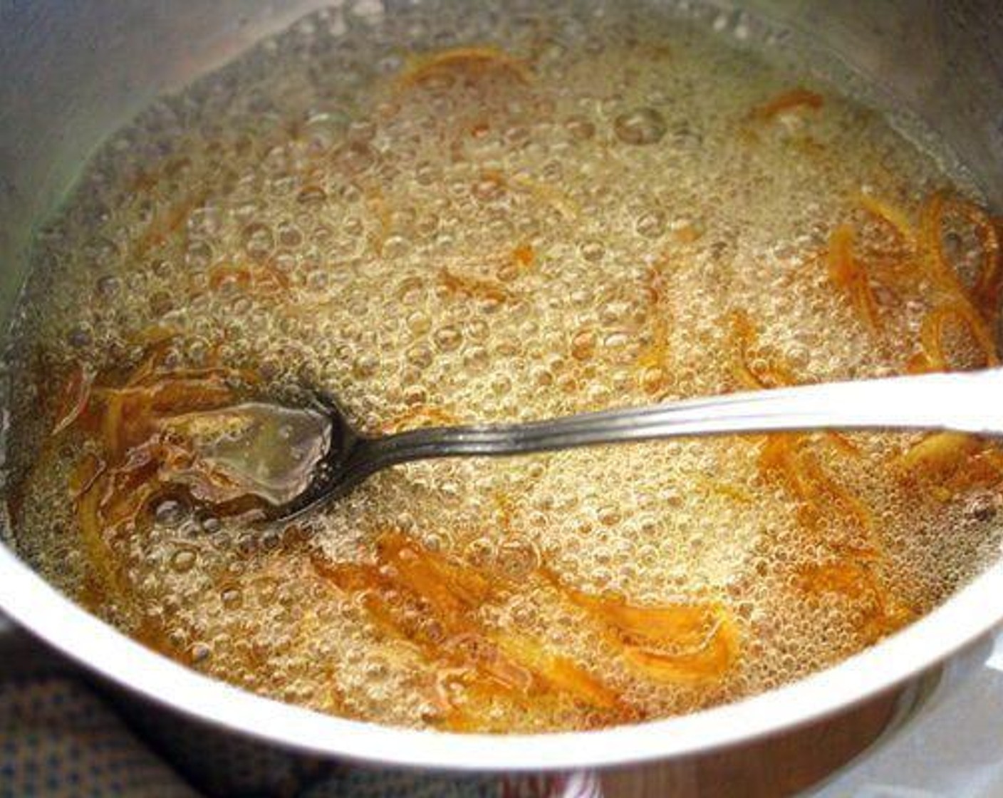 step 5 In the same pan, dissolve Granulated Sugar (1 cup) in Water (1/2 cup). Bring to a boil, then add the orange peel. Cook, stirring frequently, for 10 minutes.