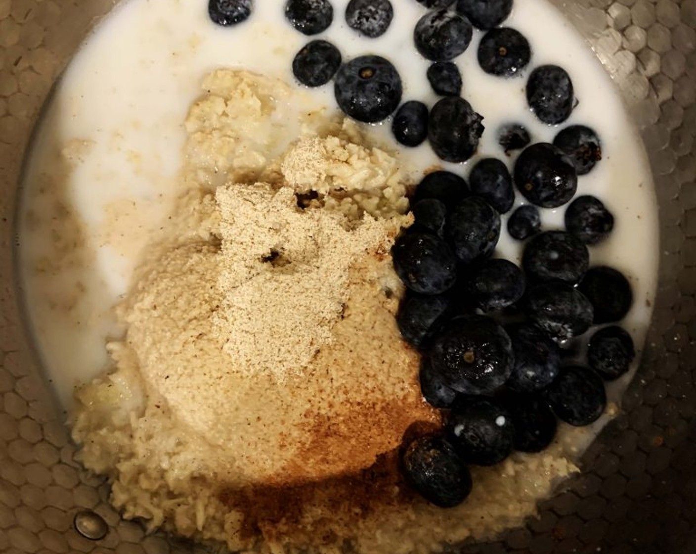 step 1 In a saucepan add Cauliflower Rice (4 oz), Almond Milk (6.5 oz), Blueberries (1/2 cup), Oat Flour (1 2/3 Tbsp), and Cinnamon (1 dash).