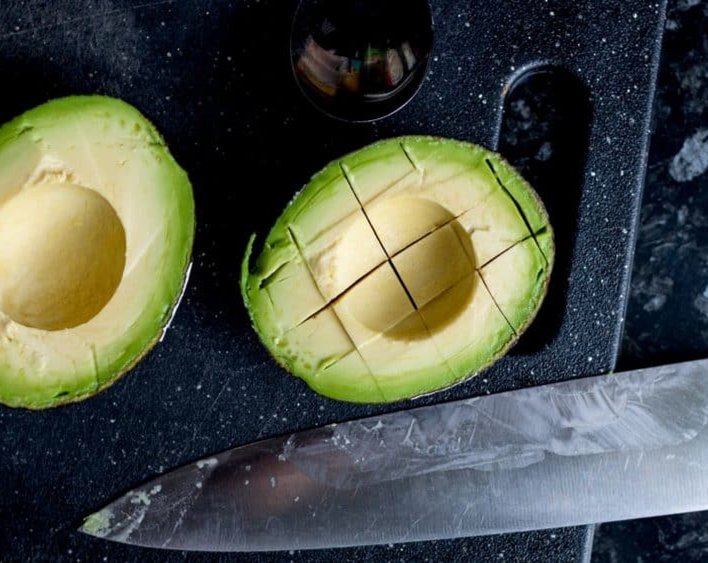 step 1 Cut the Avocados (2) in half and remove the stones. Gently make cuts in the avocado flesh in a cross-hatch pattern, being careful not to break through the avocado peel, and scoop out the flesh.