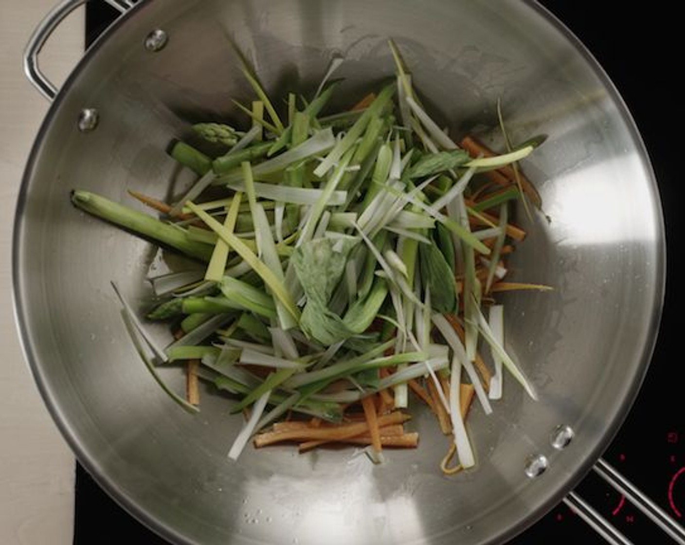 step 8 Then add the Asparagus (1 Tbsp), Leek (1 Tbsp), and Chinese Broccoli (1 Tbsp). Stir-fry for about 15-30 seconds.