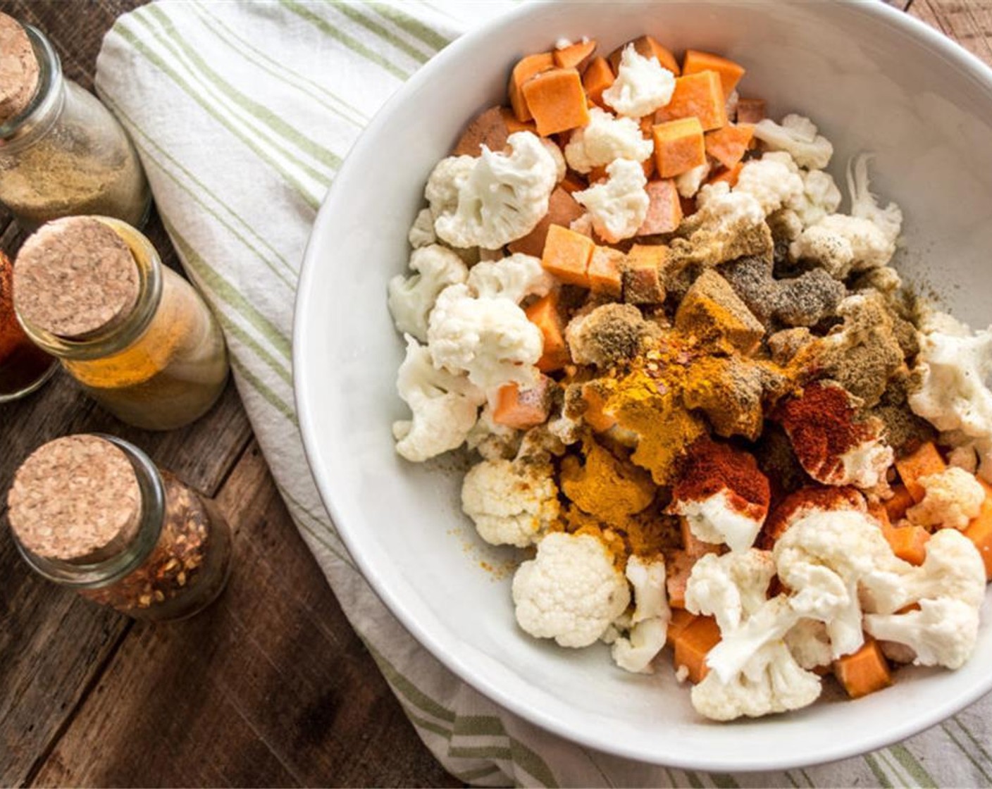 step 3 Then, toss the veggie mixture with Curry Powder (1 tsp), Ground Cumin (3/4 tsp), Ground Turmeric (1/4 tsp), Ground Coriander (1/2 tsp), Ground Black Pepper (1/2 tsp), Smoked Paprika (1/2 tsp), and Crushed Red Pepper Flakes (1/8 tsp) until evenly coated.