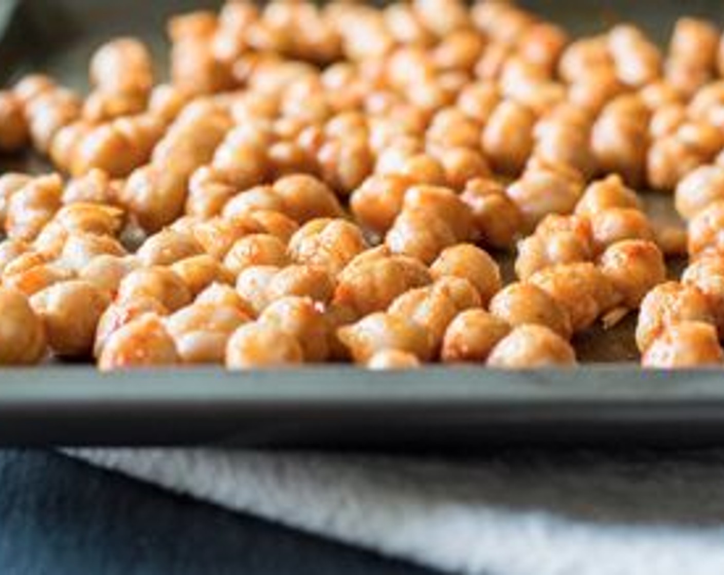 step 4 Add chickpeas to a baking sheet. Drizzle with Coconut Oil (1/2 Tbsp) and toss to coat. Sprinkle seasoning mixture over the oil-covered chickpeas, toss to fully cover, then spread seasoned chickpeas onto a baking sheet in a single layer.