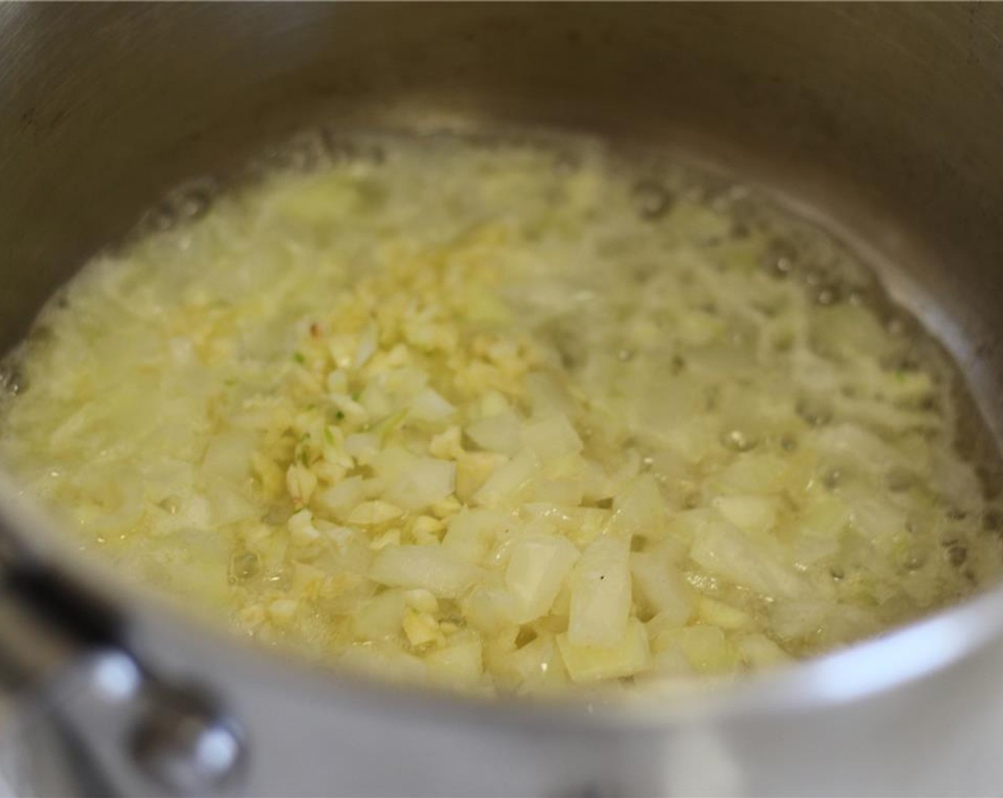 step 9 Melt the Butter (3 Tbsp) in a straight-sided pot over medium heat. Stir in the onions, garlic, and a pinch of salt. Cook for about 3 minutes, until the onions are soft and translucent.