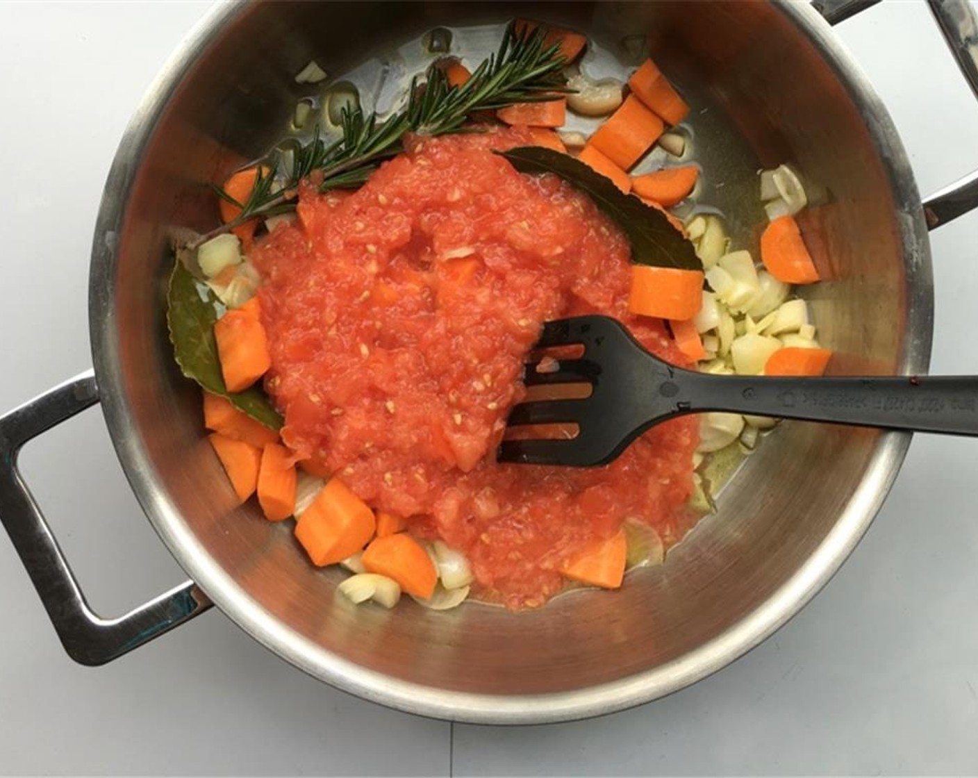 step 2 Place the casserole over medium-high heat and gently stir fry the ingredients for 4 minutes. Peel and chop up the  Carrot (1). Blend the fresh Tomatoes (2) into a pulp. Add both the tomatoes and carrot to the casserole.