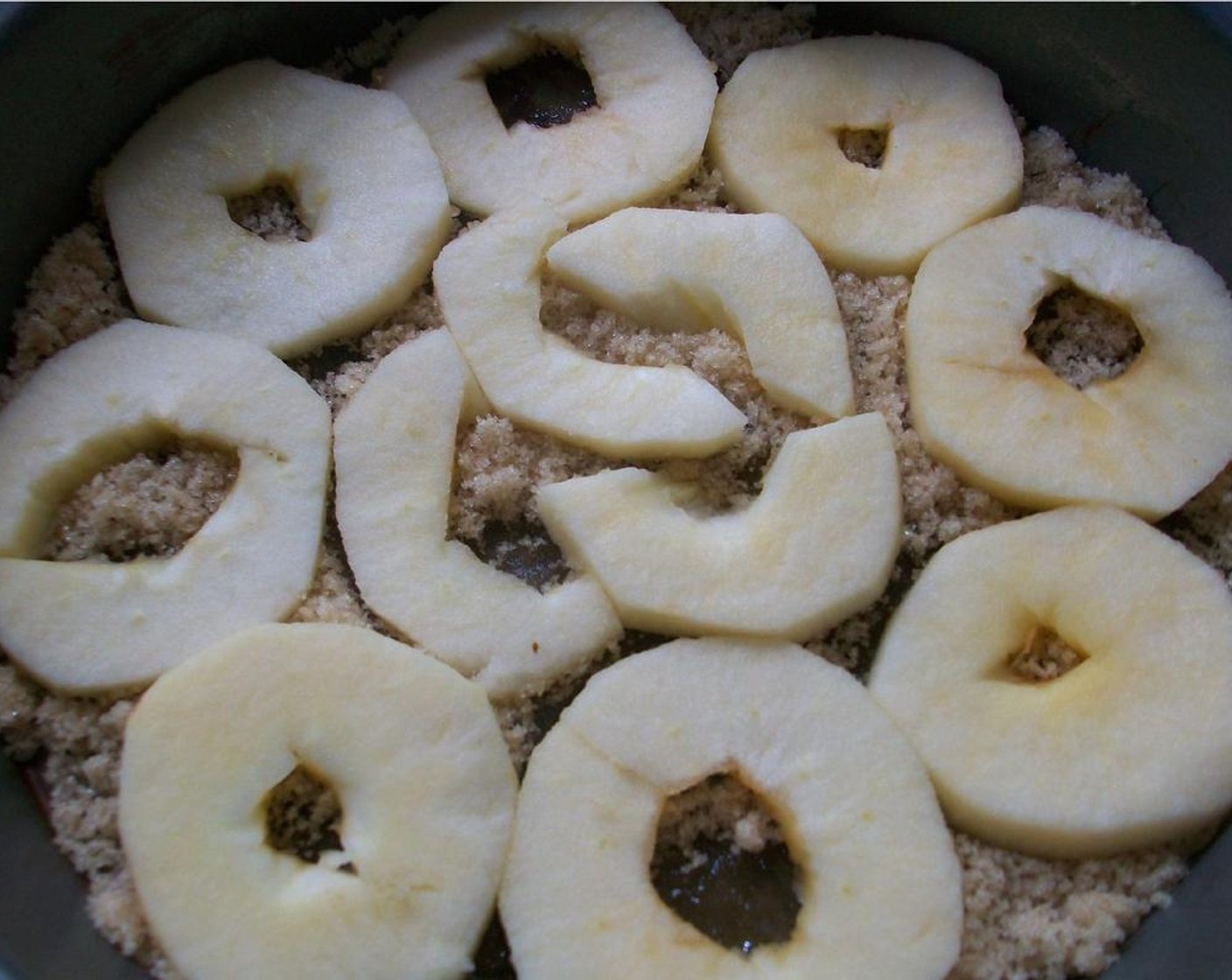 step 2 For the upside down layer, drizzle Light Corn Syrup (1 Tbsp) over bottom of pan; sprinkle with Brown Sugar (1/3 cup). Arrange the Apples (2) on top of the brown sugar.