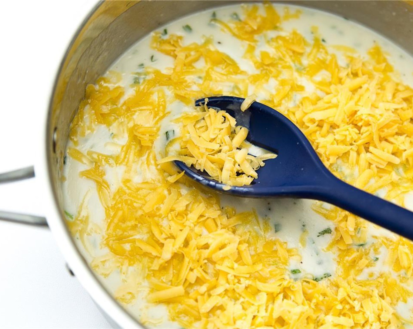 step 3 Stir in the Cheddar Cheese (1 1/2 cups), cook over low heat, stirring constantly until cheese melts.