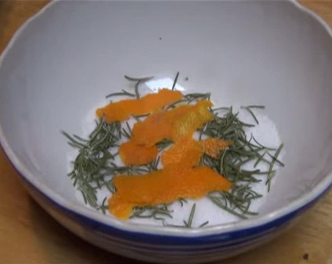 step 1 Peel the Orange (1) to create 4 long strips of orange peels. Remove the leaves from the Fresh Rosemary (4 sprigs) and discard the stems.