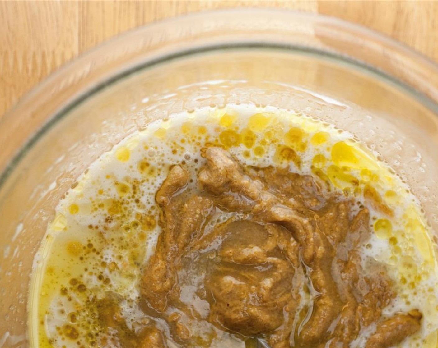 step 2 In a large bowl, mix together the wet ingredients: Creamy Natural Peanut Butter (1/3 cup), Olive Oil (2 Tbsp), Vegan Sugar (3/4 cup), Coconut Milk (1/3 cup), and Kahlua (1 tsp). Stir until well combined.