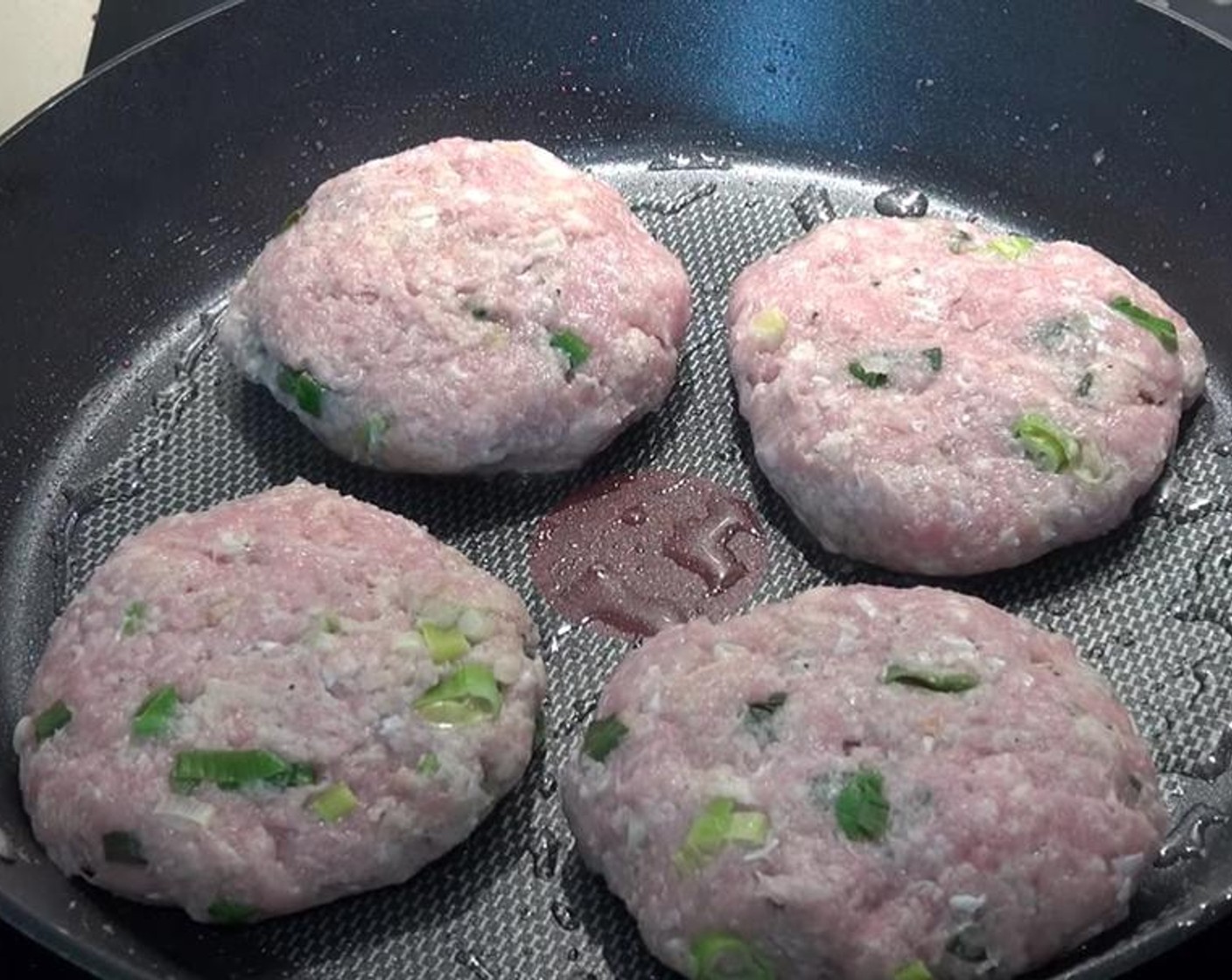 step 5 Reusing the same frying pan from before, add a little more Olive Oil (to taste). Cook patties over medium to high heat.