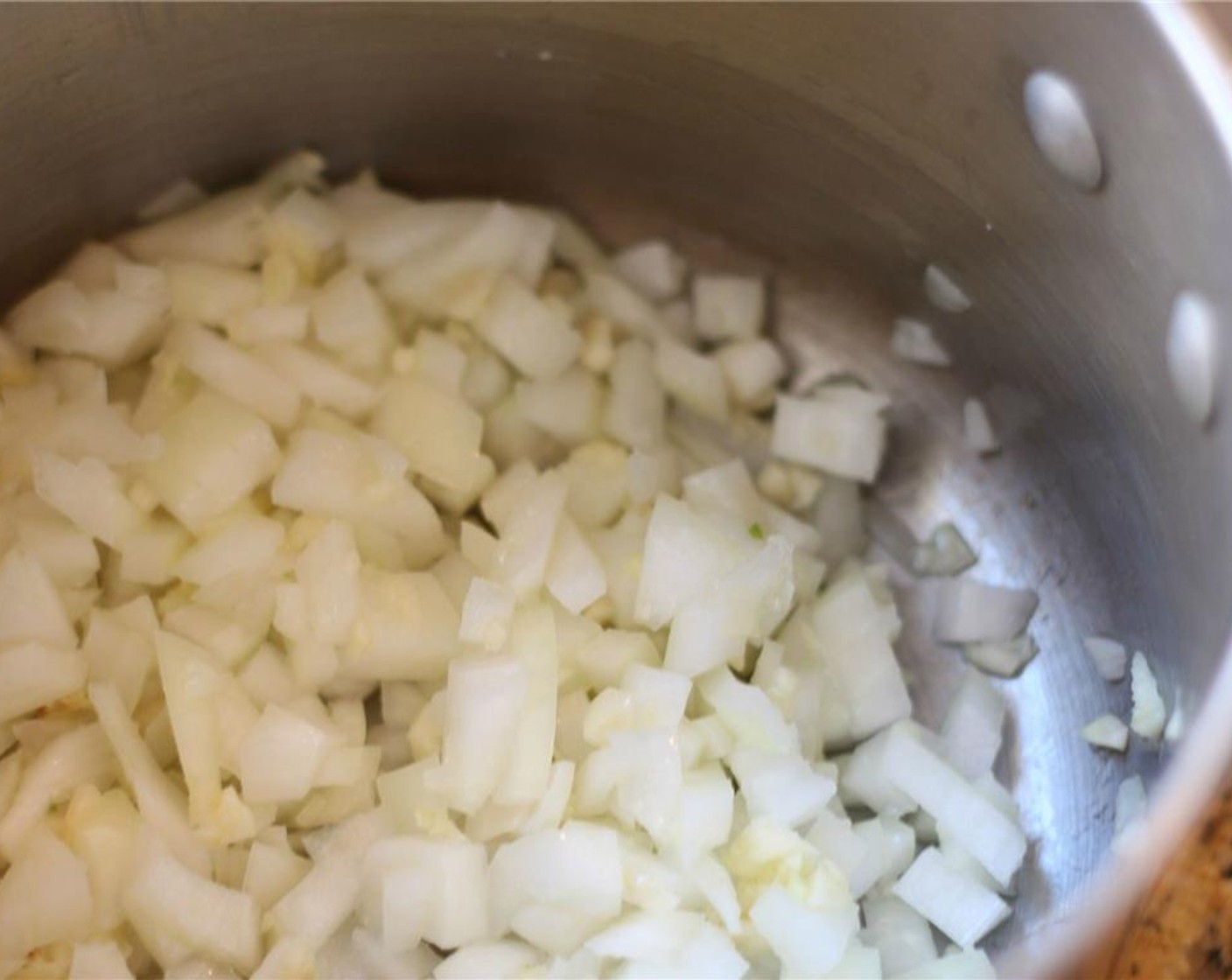 step 3 In a stock pot over medium heat, melt the Unsalted Butter (1/4 cup). Sauté the garlic and onion until translucent.