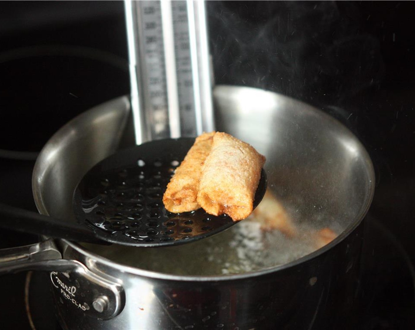 step 8 Working in small batches, add rolls to the oil and fry until golden brown in color. Remove with a slotted spoon to a plate lined with paper towels. Continue with all rolls.