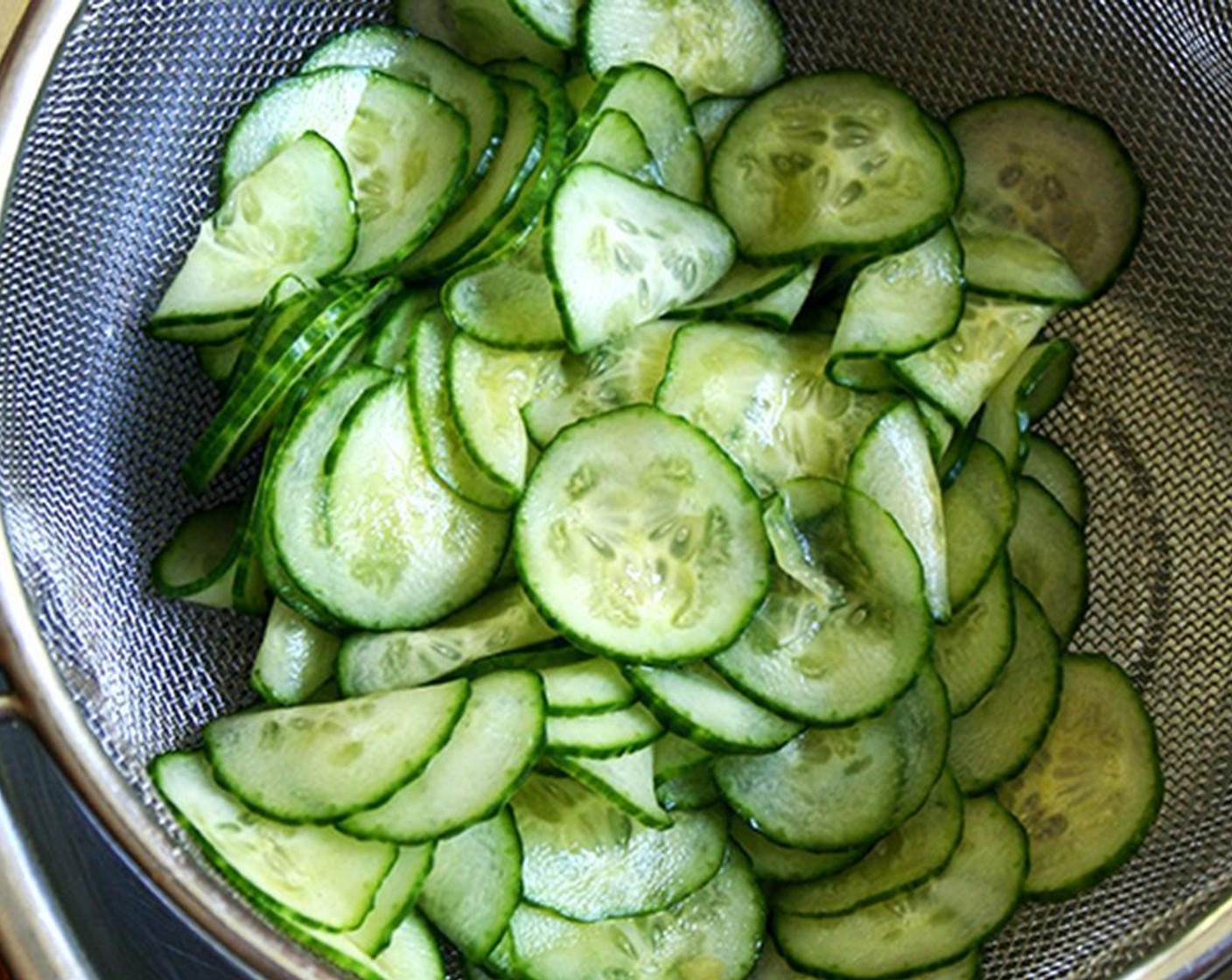 step 1 Slice Japanese Cucumbers (2 cups) crosswise 1/8-inch thick and toss with Fine Sea Salt (1 tsp). Let stand 30 minutes, then rinse well and squeeze out excess liquid with your hands.