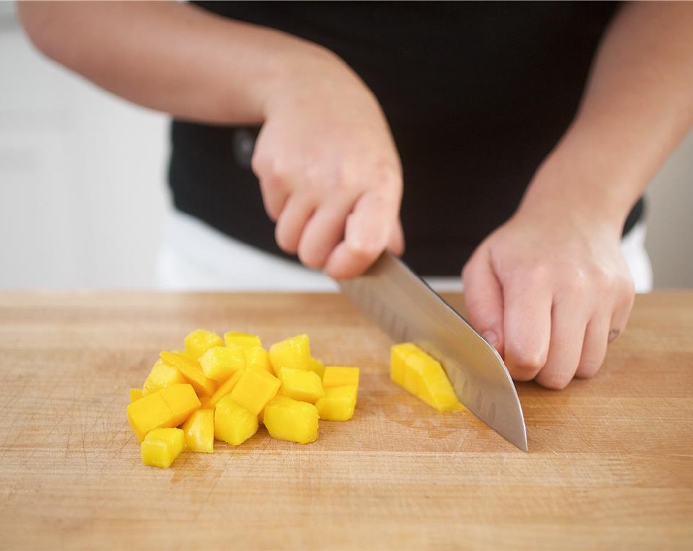 step 2 Peel skin off Mango (1/2) and remove mango flesh from pit. Discard pit in dice into 1 inch pieces.