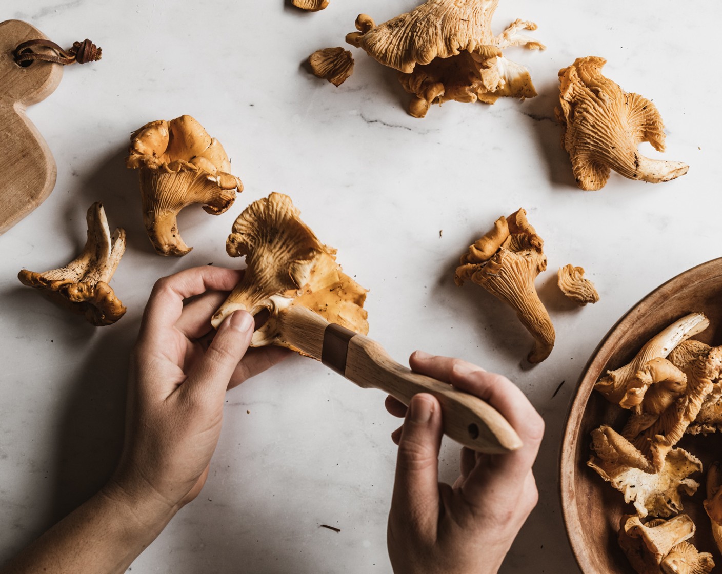 step 3 Use a pastry brush to remove loose dirt from the Chanterelle Mushrooms (8 1/3 cups). Use a damp paper towel if there is any stubborn dirt. Once the mushrooms are clean, tear the mushrooms into smaller pieces.