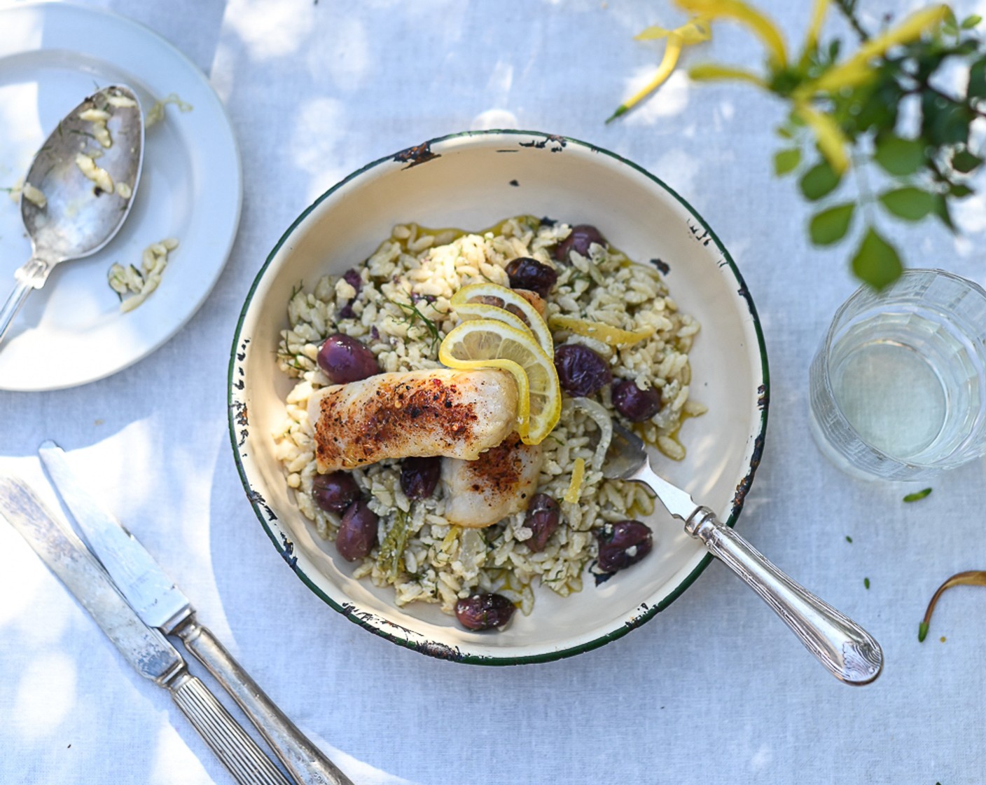 step 9 Spoon the orzo onto each plate and top with a Cape hake medallion. Serve with Lemon Wedge (1). Enjoy!