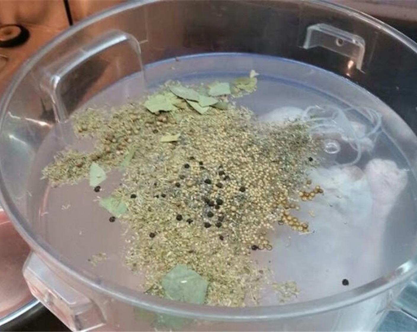 step 1 Begin by preparing the brine. Chop the Garlic (4 cloves). Fill a deep plastic container with Water (27 cups) and mix in Sea Salt (3/4 cup), Whole Coriander Seeds (1 Tbsp), Black Peppercorns (1 Tbsp), Mustard Seeds (1 Tbsp), Fresh Thyme (1 Tbsp), Fresh Rosemary (1 Tbsp), Fresh Sage (1 Tbsp), garlic and Bay Leaves (6) until the salt dissolves.