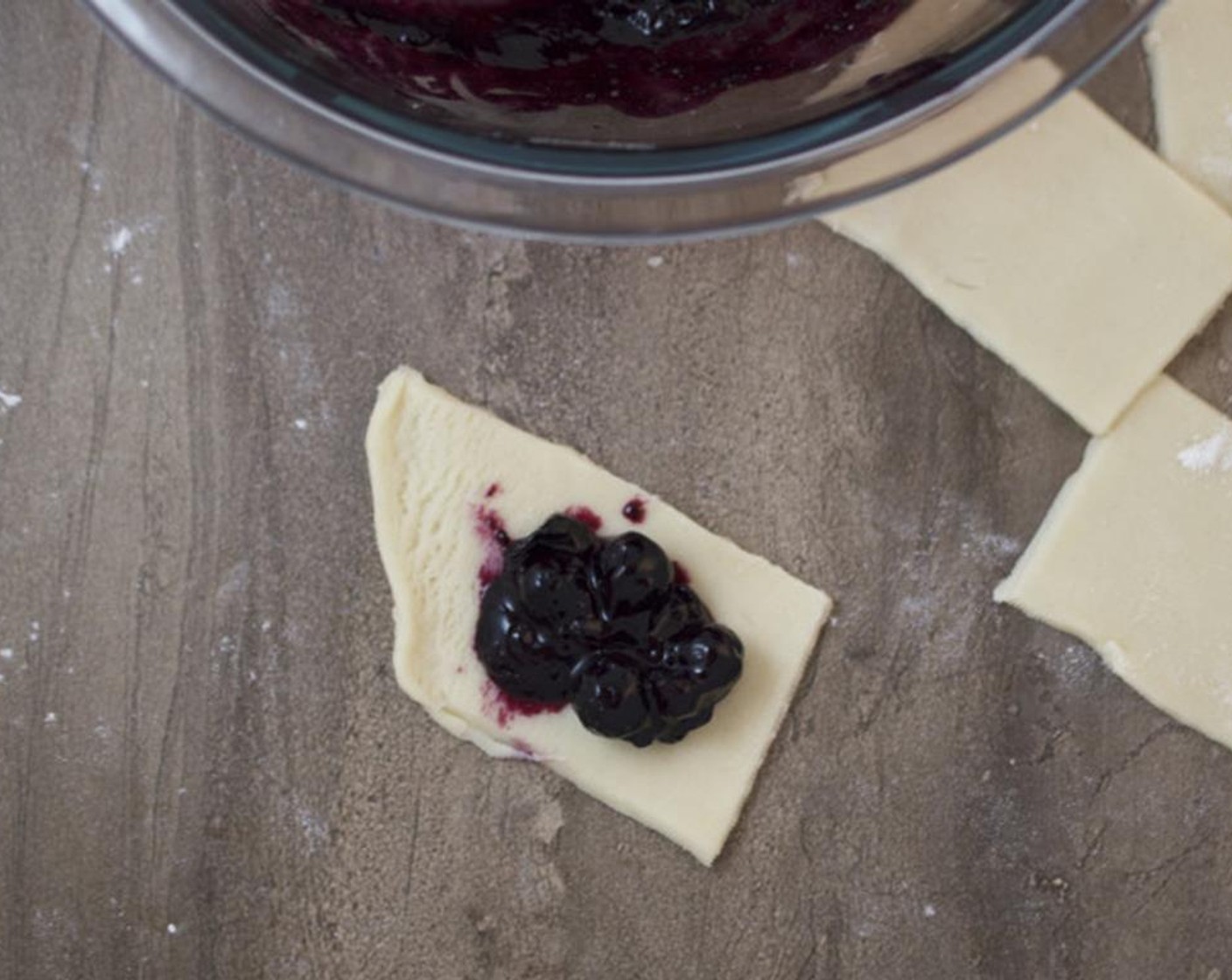 step 5 Top each piece of pie dough with 1 teaspoon of the blueberry pie filling.