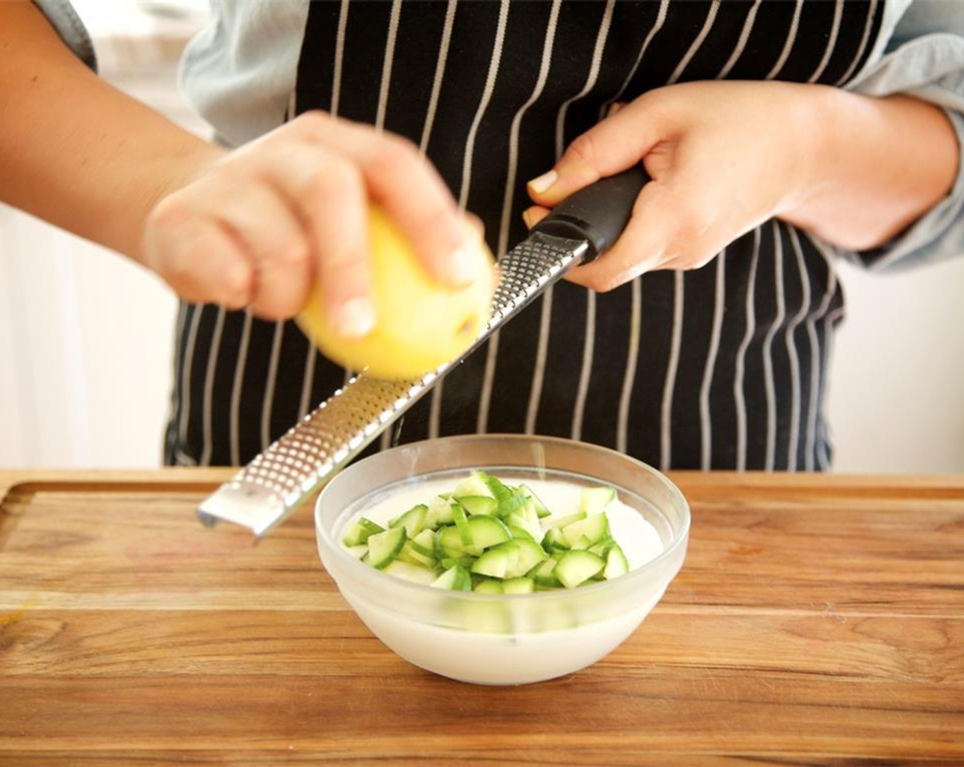 step 11 Rinse and pat dry small bowl used for onion and chili. In the small bowl, combine half a cup of the Greek Yogurt (1/2 cup), the cucumber, and salt. Zest the Lemon (1) directly into the bowl. Stir well and reserve for plating.
