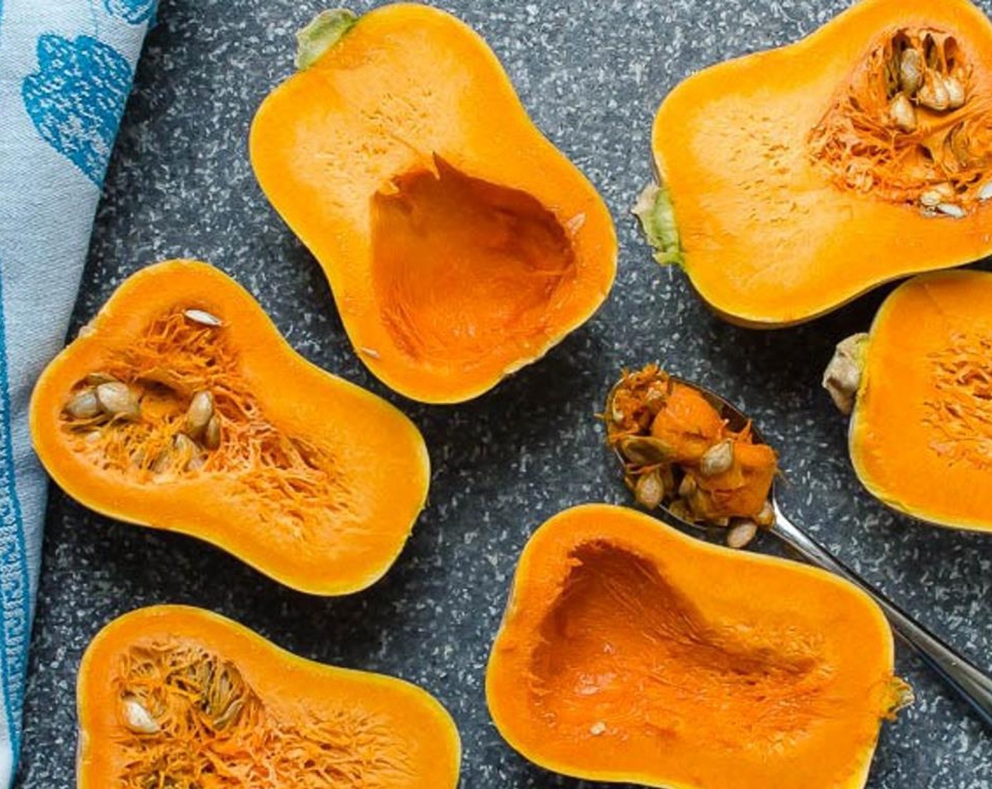 step 3 Cut the Honeynut Squash (3) in half vertically, and scoop out the seeds. Drizzle the cut side with Olive Oil (1 Tbsp) and rub it into the flesh.