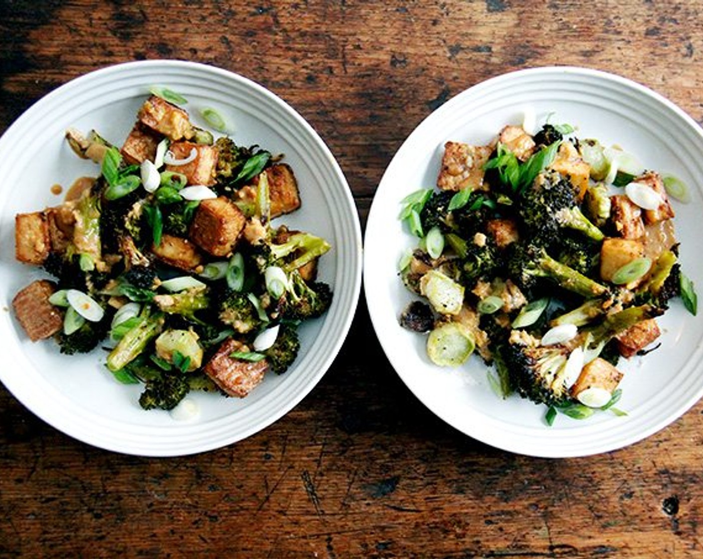 step 8 To finish: In a large bowl, combine the broccoli and tofu, and toss with some of the sauce. Garnish with the Scallion (1 bunch). Serve Chili Garlic Sauce (to taste), if using, on the side.