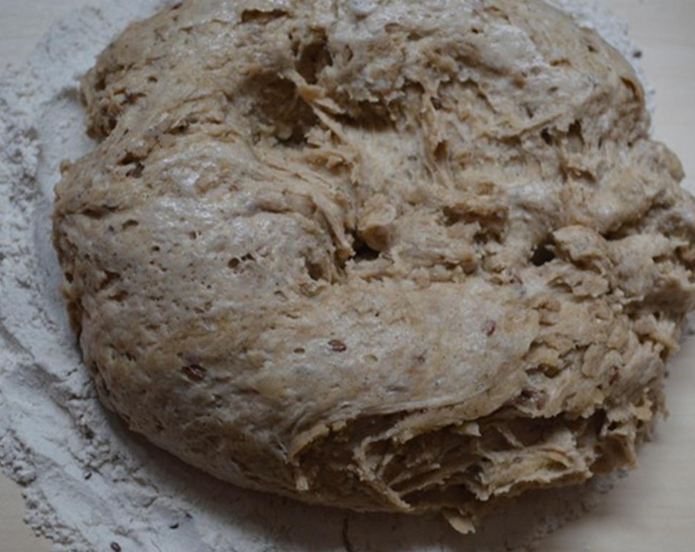 step 2 In a separate bowl, combine Multigrain Flour (310 g), Cake Flour (70 g), Salt (1 tsp), Butter (2 Tbsp), and Sunflower Oil (120 mL). Add yeast mixture and stir into soft dough.