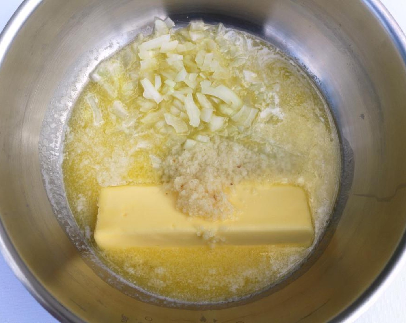 step 4 In a medium saucepan, melt the Butter (1 stick), Saute Shallot (1 Tbsp) and Garlic Paste (1 Tbsp) until onions are translucent.