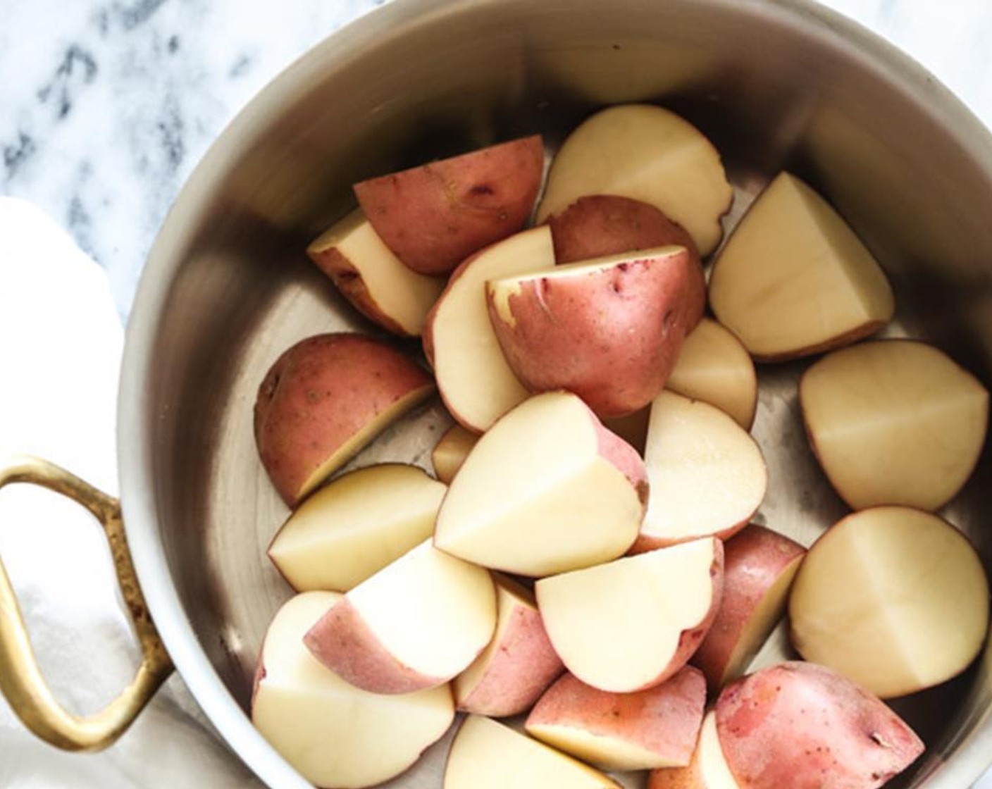 step 2 Meanwhile, place the Red Potatoes (6 cups) in a large saucepan or stockpot and cover with well-salted cold water by 2 inches. Bring to a boil and simmer until the potatoes are fork tender, about 15 minutes. Drain well and transfer to a large mixing bowl.