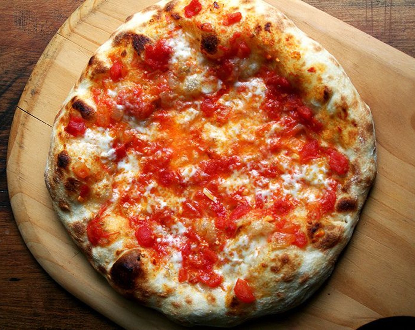 step 11 Remove pizza from oven using your peel — a pair of tongs might help, too. Transfer pizza to cutting board.