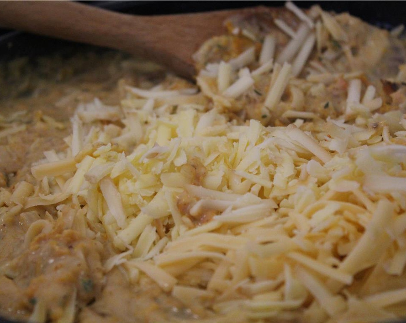 step 14 Stir in the grated cheeses (reserve about ¾ cup of the cheeses for the topping) until melted and smooth. Whisk in additional milk as needed to loosen the sauce.