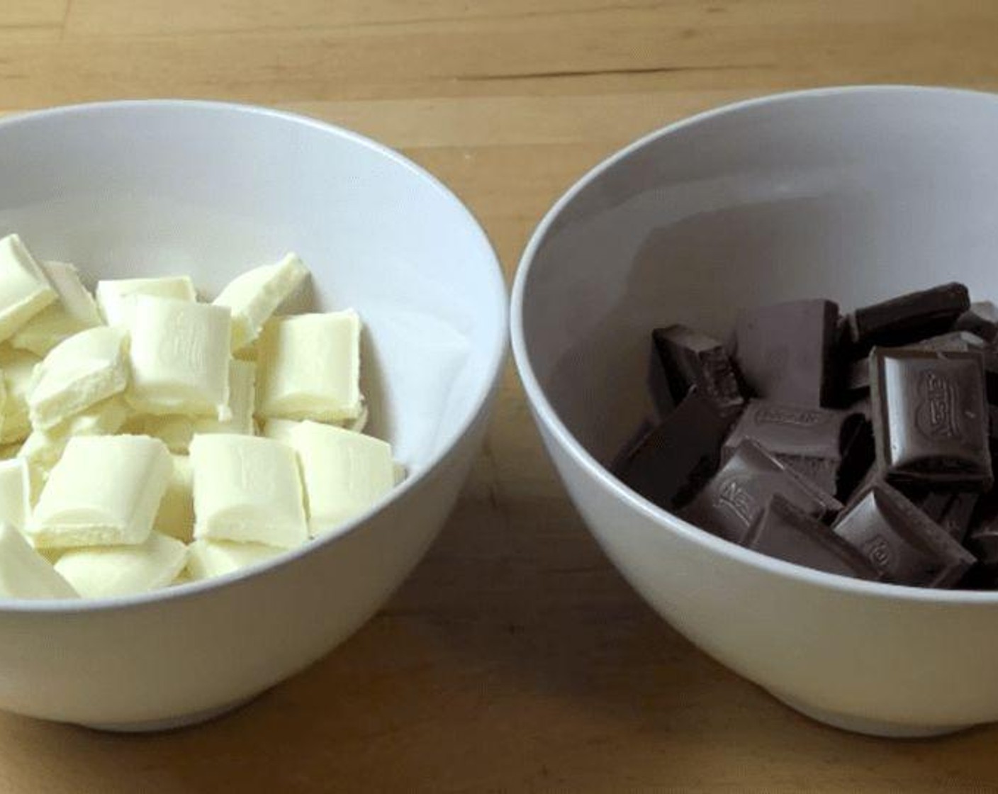 step 1 Put the White Chocolate (1 cup) and the Dark Chocolate (1 cup) pieces into separate bowls. Melt the chocolate in both bowls.