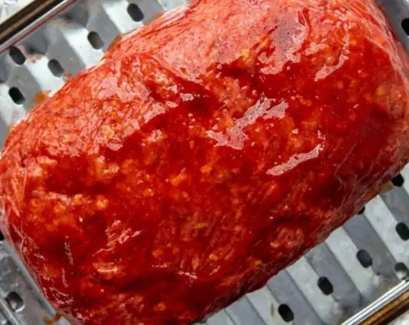 step 6 After 45 minutes, turn the oven up to 400 degrees F (200 degrees C). Remove the meatloaf and brush on the remaining glaze.