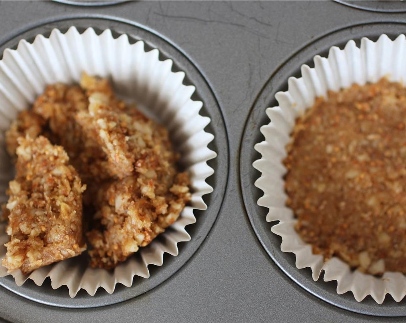 step 4 Place muffin liners in a muffin tin. Using a spoon and your hands, pack the crust into the liners.