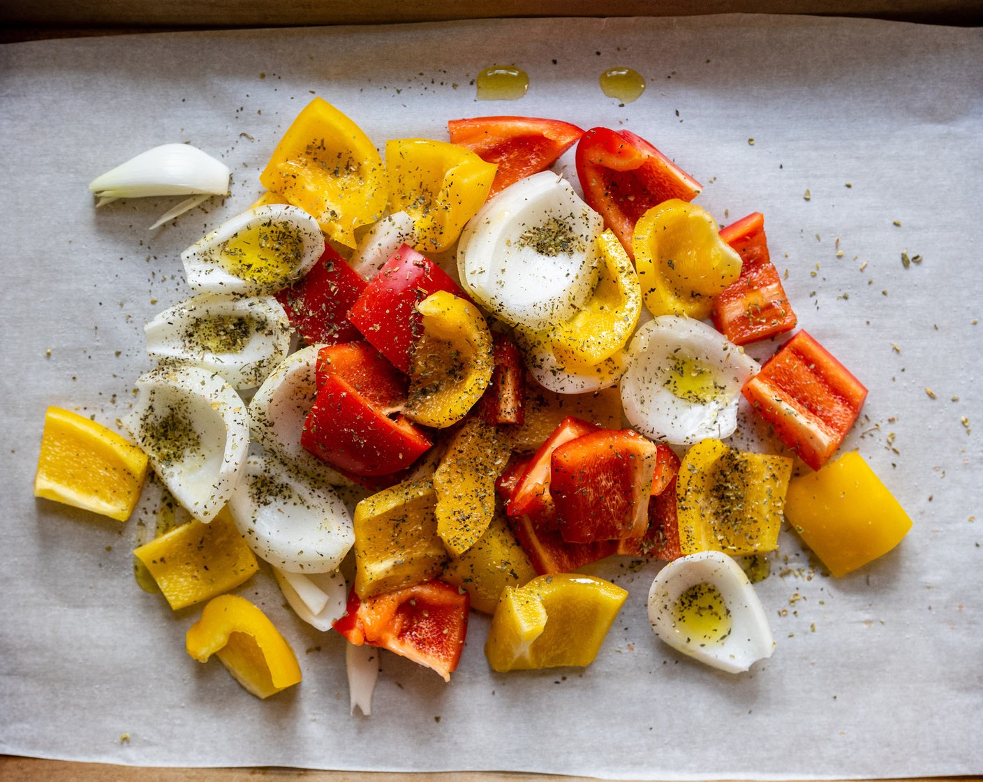 step 2 On a large baking sheet, place the Onion (1) and Bell Peppers (2). Drizzle with Olive Oil (1 1/2 Tbsp) and sprinkle with Italian Seasoning (1/2 tsp), Dried Oregano (1/4 tsp), Salt (1/4 tsp), and Ground Black Pepper (1/8 tsp). Use your hands to toss and coat the veggies with oil and seasonings.