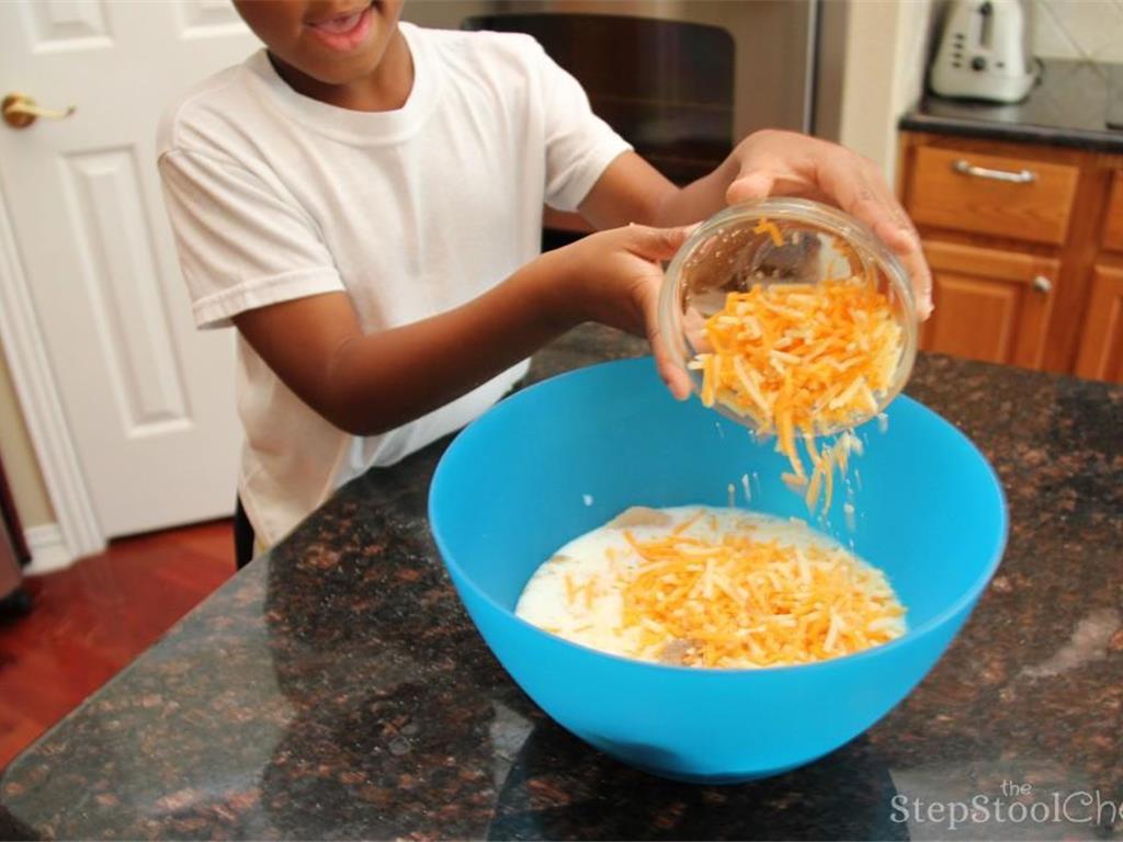 Step 5 of Chicken Broccoli and Rice Casserole Recipe: Add in the Whole Milk (2 cup) and Shredded Cheddar Cheese (2 cup).