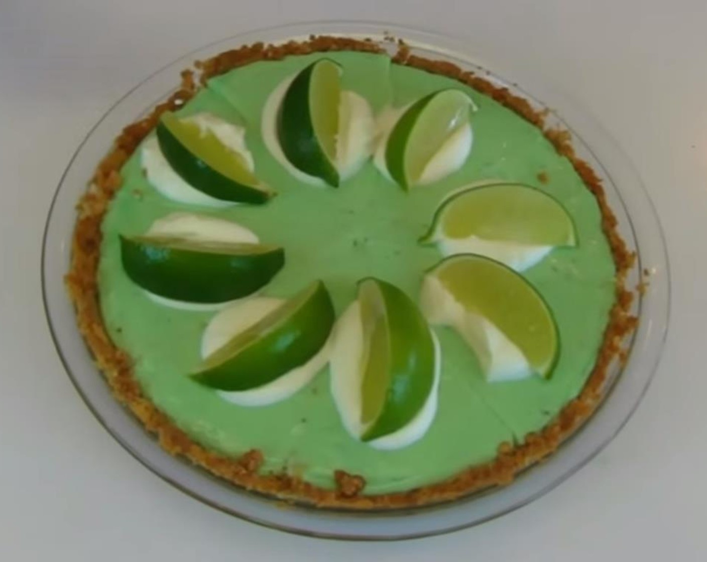step 11 Remove from refrigerator and cut into 8 equally-sized wedges. Place a dollop of reserved sweetened whipped cream on the top of each pie wedge. Place the Limes (8 slices) on top of each of the dollops of whipped cream.