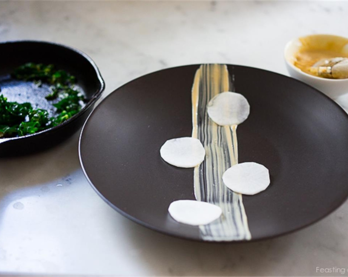 step 12 Plating doesn’t have to be intimidating. Have a plan. Do a practice plate. For this presentation, simply brush the miso aioli across the plate, either in the middle or to one side. Place the daikon along the line.